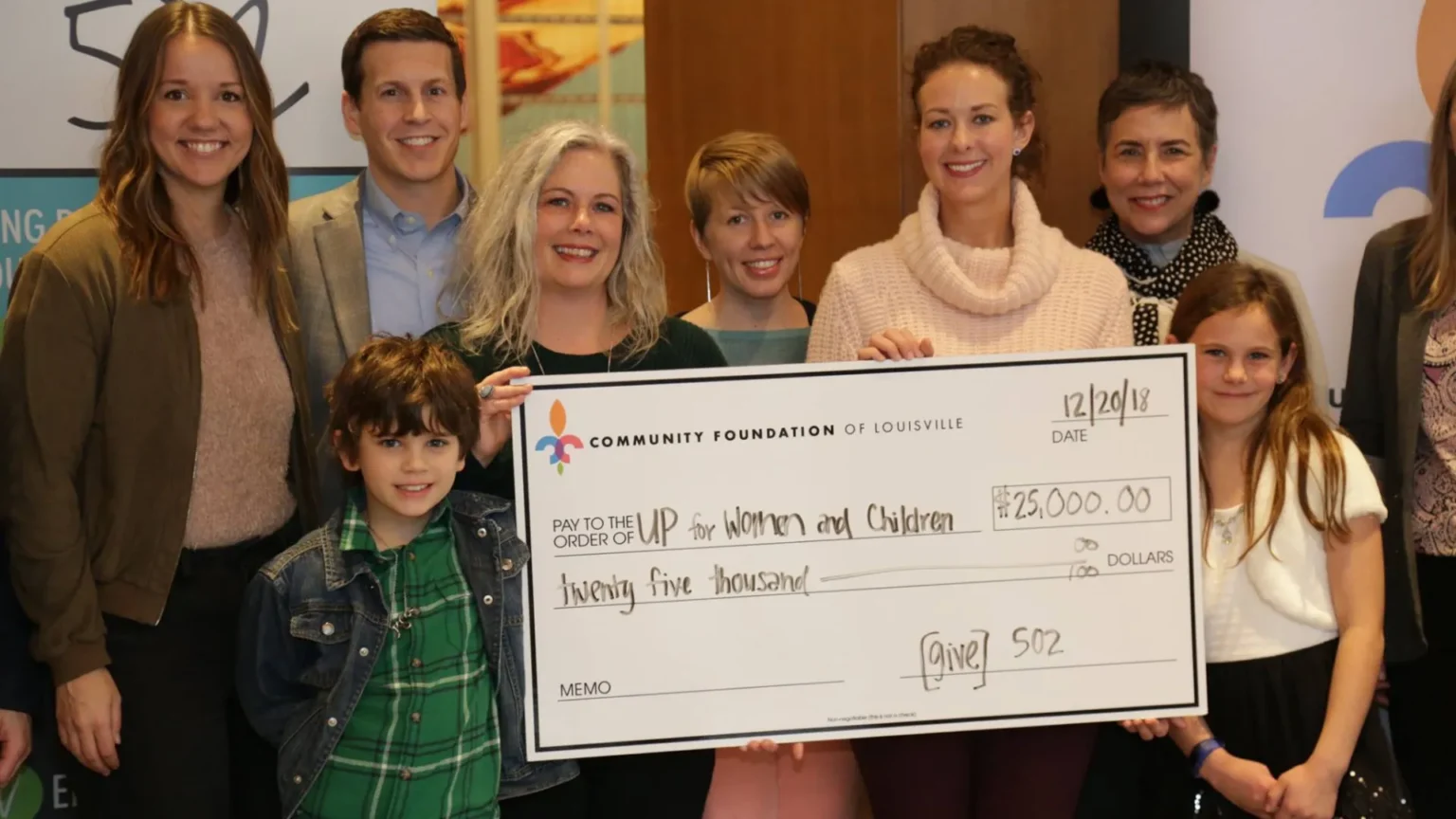 Group of people holding $25,000 check for the Community Foundation of Louisville